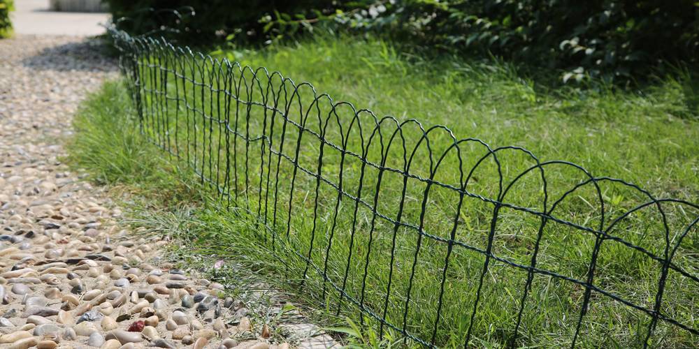 Garden border fence with dark green color for grass lawn.
