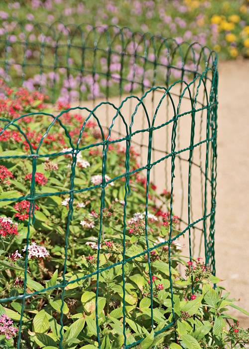 Garden border fence with dark green color for flower bed.