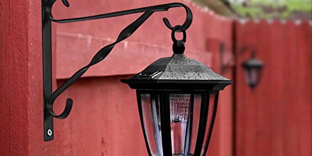 Use black plant hanging bracket to hanging solar light attached to the wall.