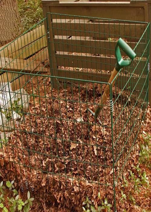 Green wire compost bin used to collect shredded leaves.