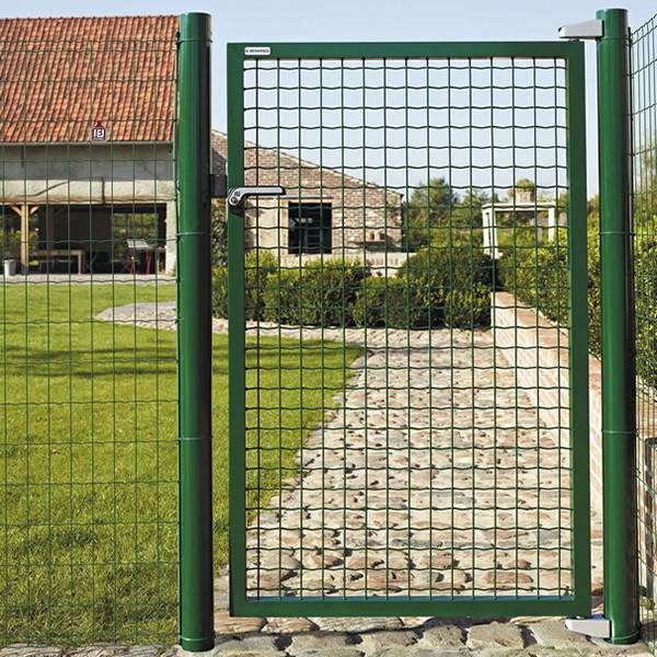 Metal garden gate installed on the cobbled road as a courtyard entryway.
