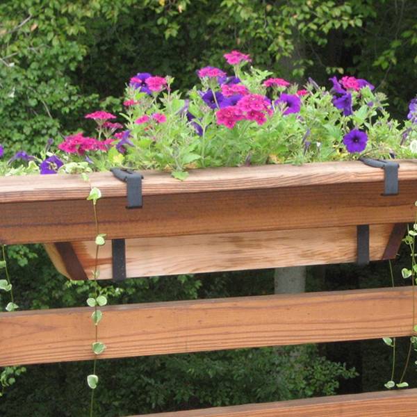 Plant pot bracket hang on the wooden deck rail for large flower pot.